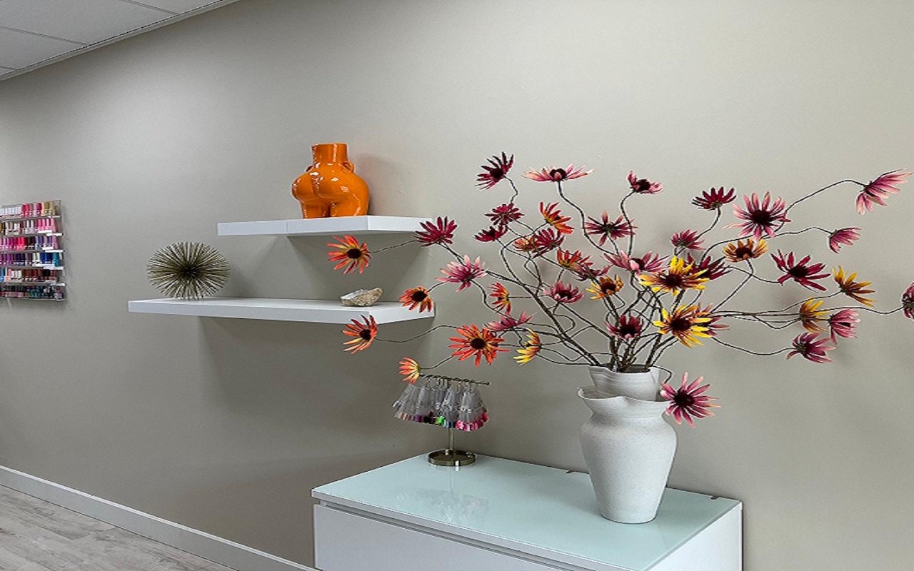 Wandplanken met een oranje vaas en bloemen